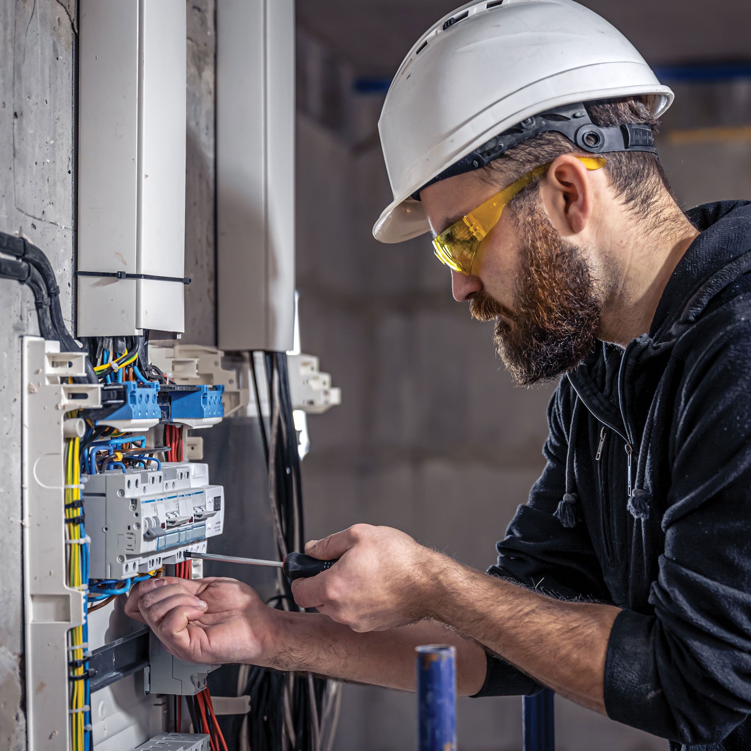 Electrician connecting electrical cable to EV charging system