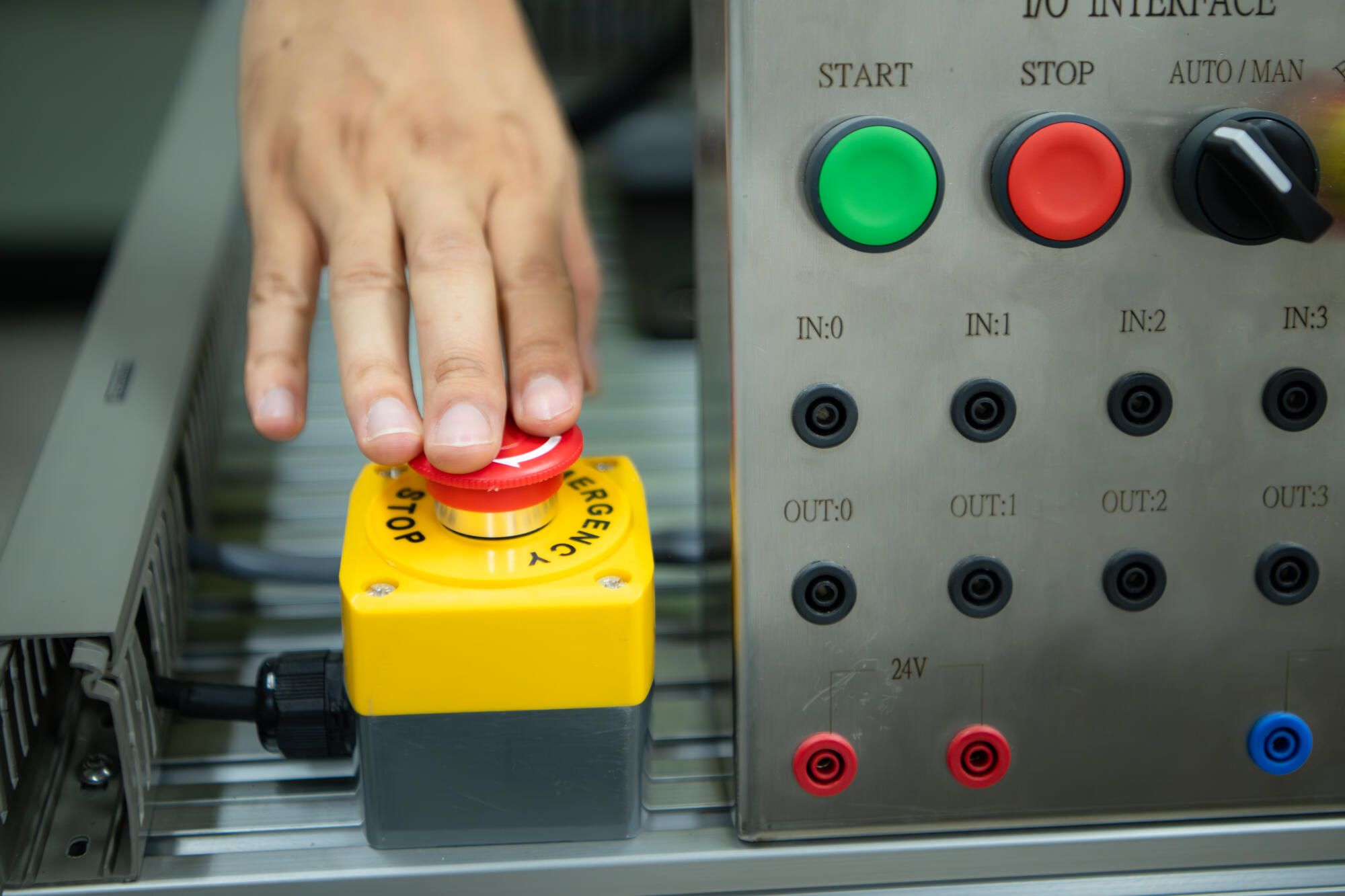 Hand pressing an E-Stop
